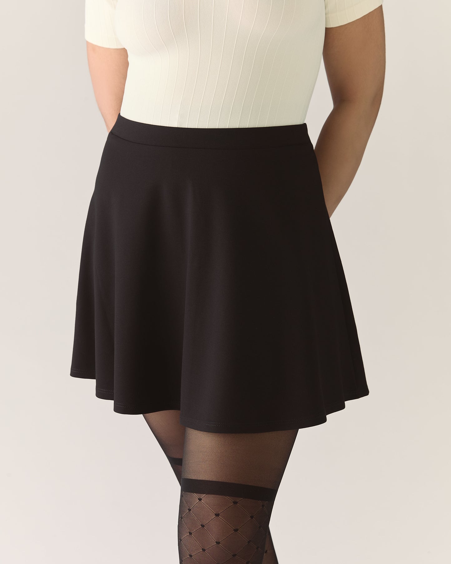 Person wearing a black skirt and white top 