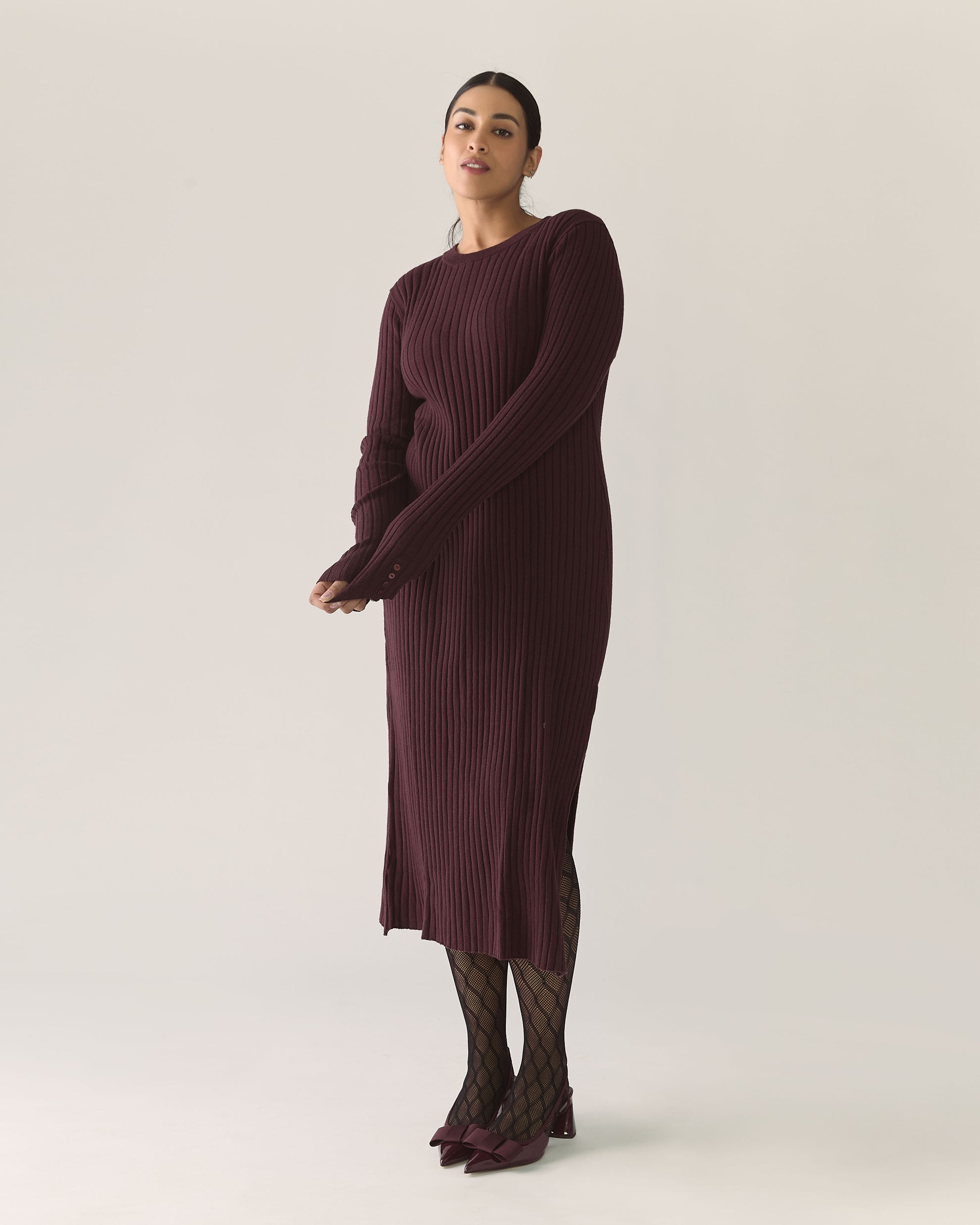 Woman wearing a long burgundy plum ribbed dress