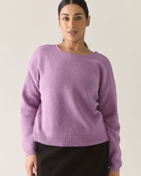 Woman wearing a lilac purple cardigan sweater